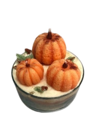 vela en envase de vidrio con figuras