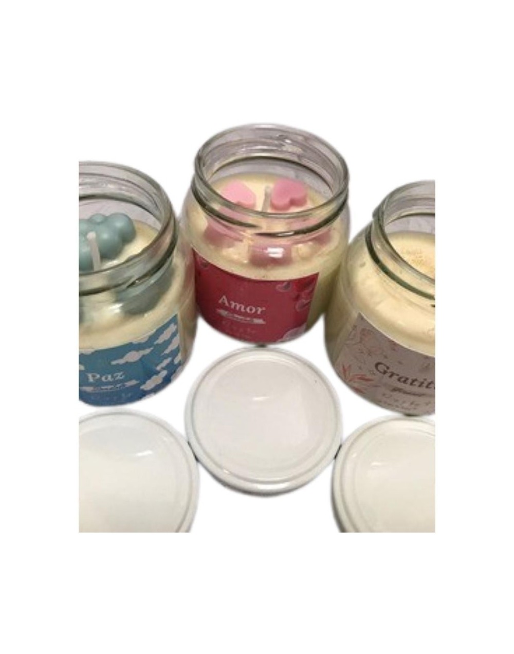 vela en envase de vidrio con figuras intensiones